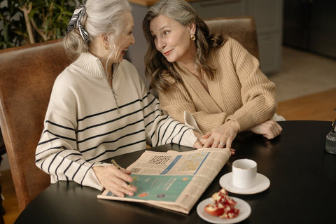 Mental Fitness - 2 older women solving a crossword puzzle