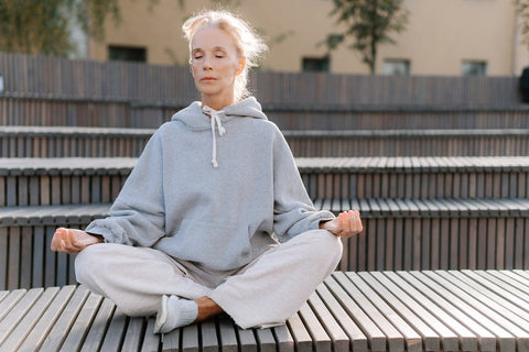Mental Fitness - Woman sitting cross-legged while meditating