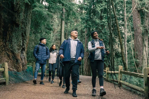 Walking for Wellness - Group of friends hiking a trail in the woods