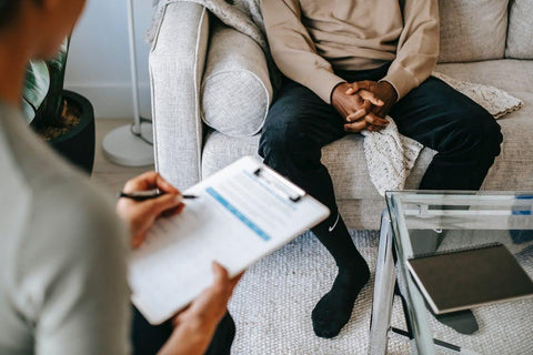 The Science of Winter Blues: Beating Seasonal Affective Disorder (SAD) - Therapist talking to a patient, holding clipboard