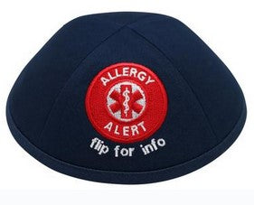 Black iKIPPAH brand yarmulke with a bright red allergy alert patch.