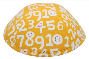 A bright yellow iKIPPAH brand yarmulke with many large white numbers from one to ten.