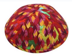 An iKIPPAH brand yarmulke that looks like flame tips in yellow, red, and orange.