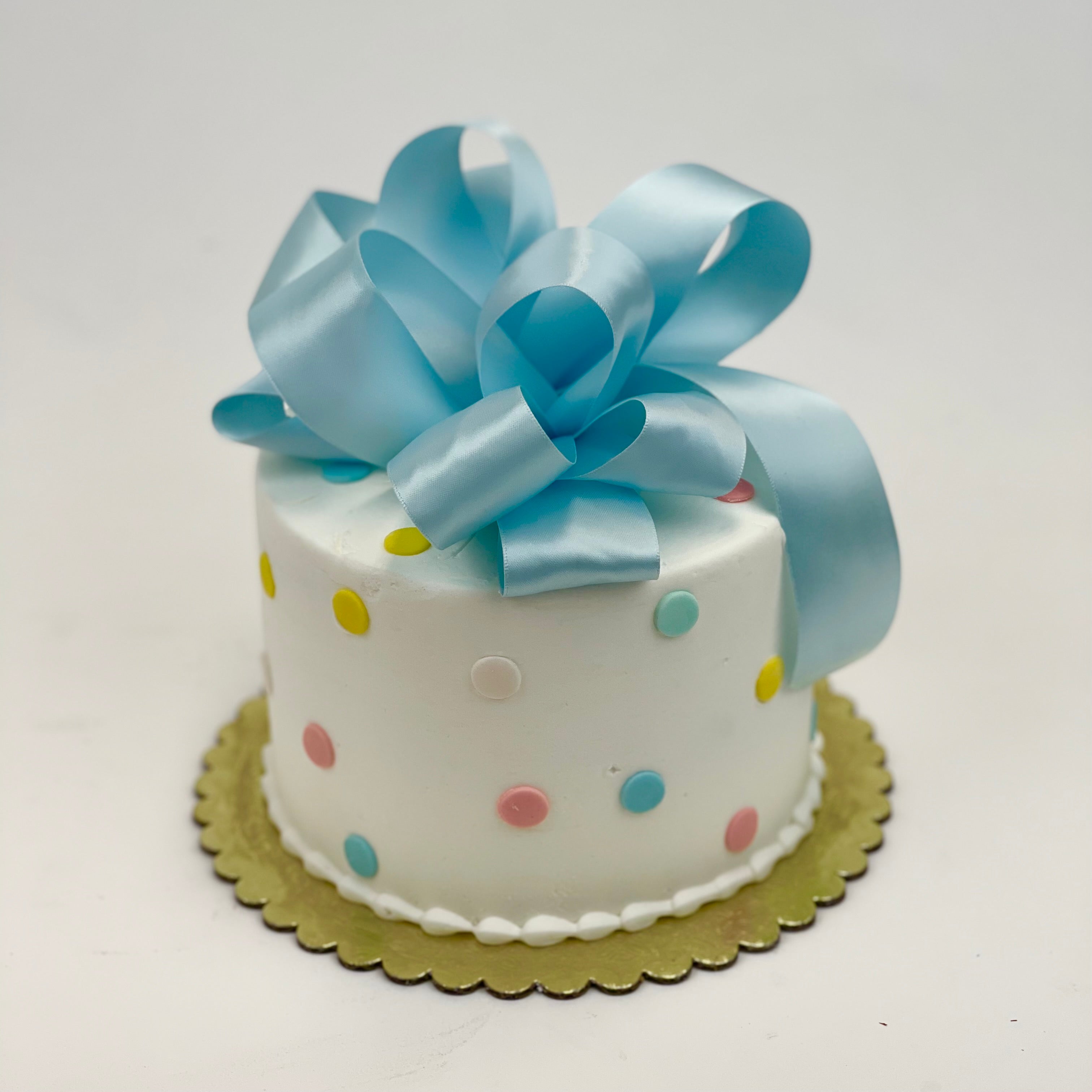 Yellow And Blue Polka Dots On White Cake
