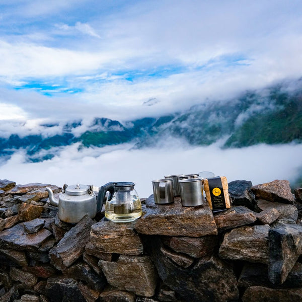 Tea Pot, Tea Pouch and different tea items showcased in the lap of Himalayas