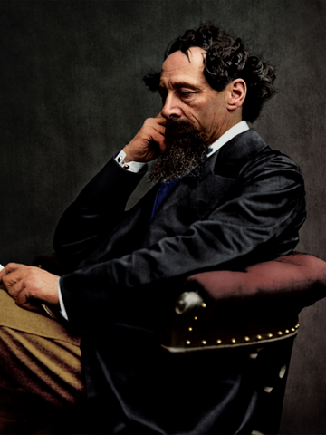 Dickens, sitting in thought. 