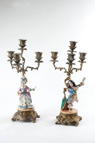 Pair of candlesticks, one with female figurine, one with male figurine