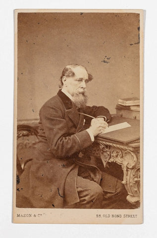 Carte de visite, front view with photograph of Charles Dickens seated at writing desk