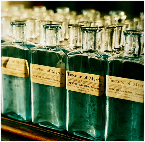 Tincture of Myrrh, emerald green vintage glass bottles, photograph by Richard Heeps.