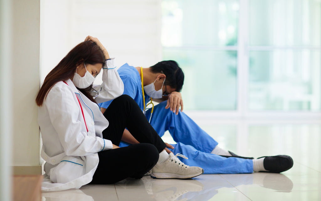 male female nurses tired exhausted sitting masks