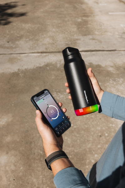 A person using a smart water bottle.