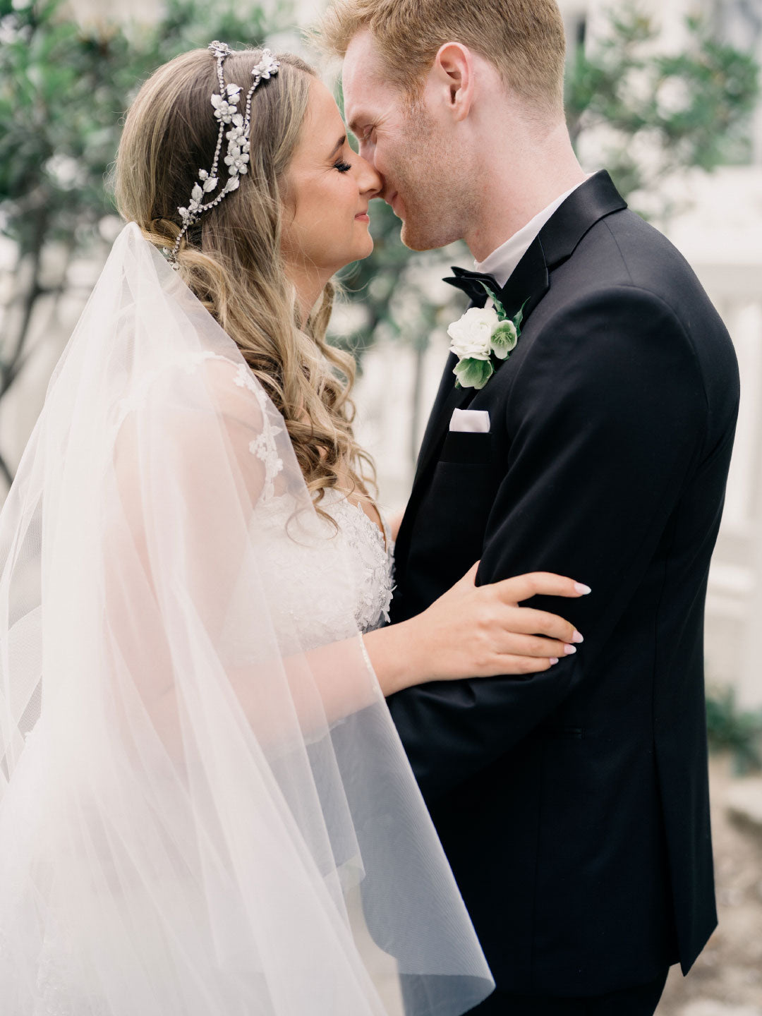 Bridea and Groom Embrace Groom in Black Tux