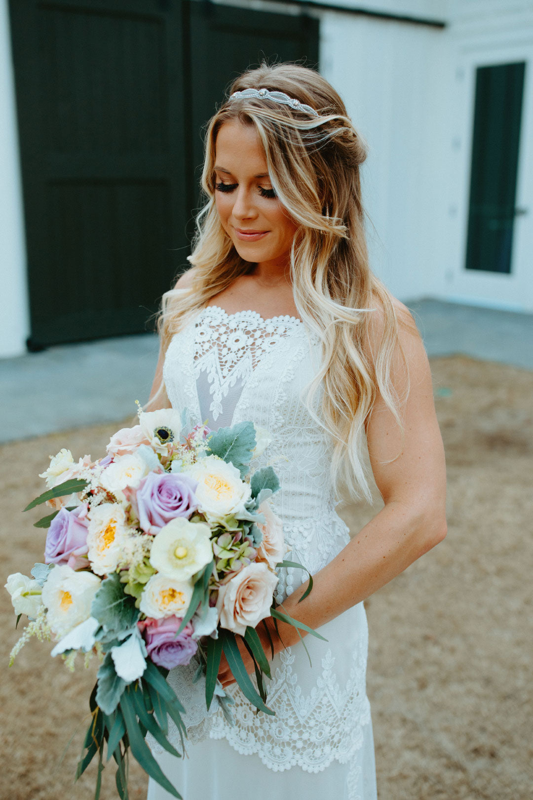 Bride holding colorful wedding bouquet wearing Victoriana by Claire Pettibone