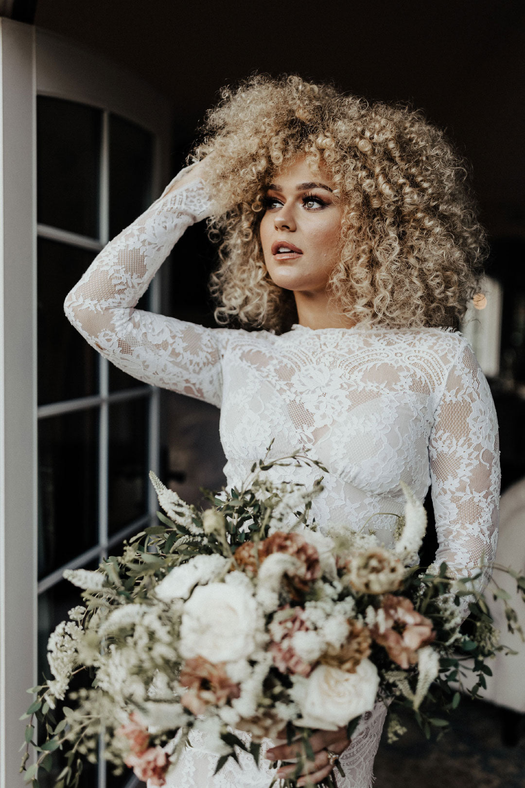 Bride with wedding bouquet arrangement