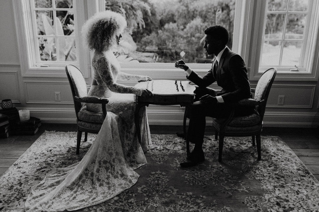 Bride and Groom seated at chess board