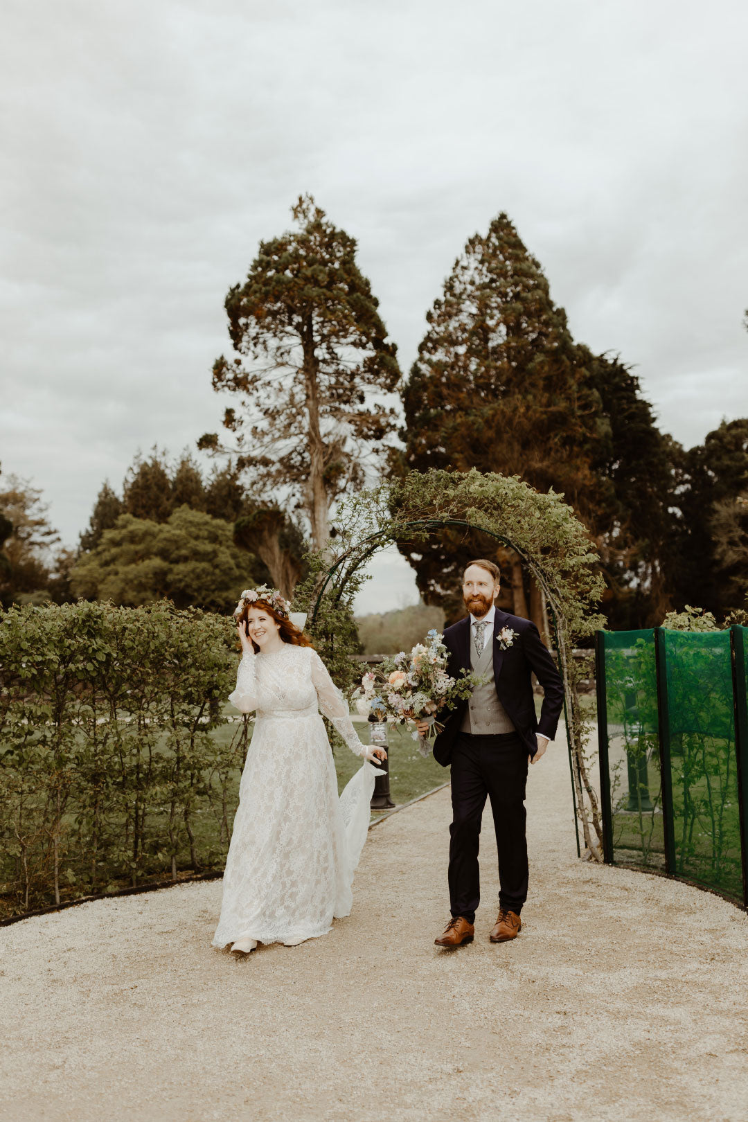 Bride and Groom Walking in Gardens of Wedding Venue