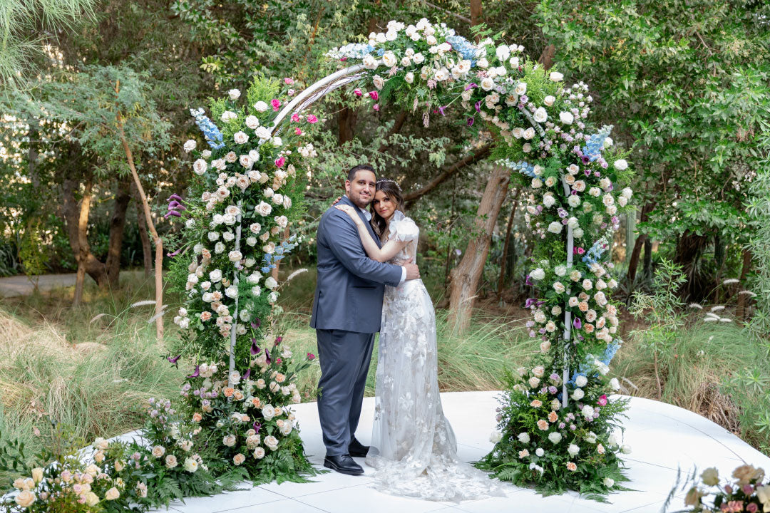 Bride and Groom under wedding floral arrangement