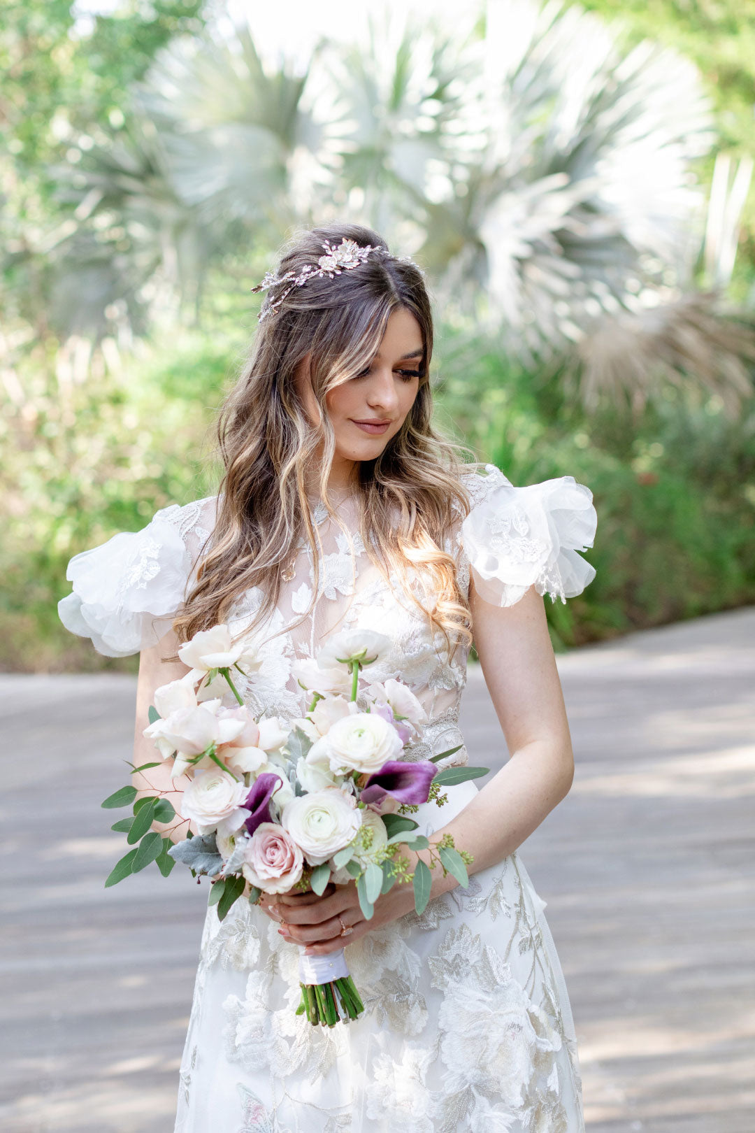 Bride holding wedding bouquet wearing Chloris by Claire Pettibone