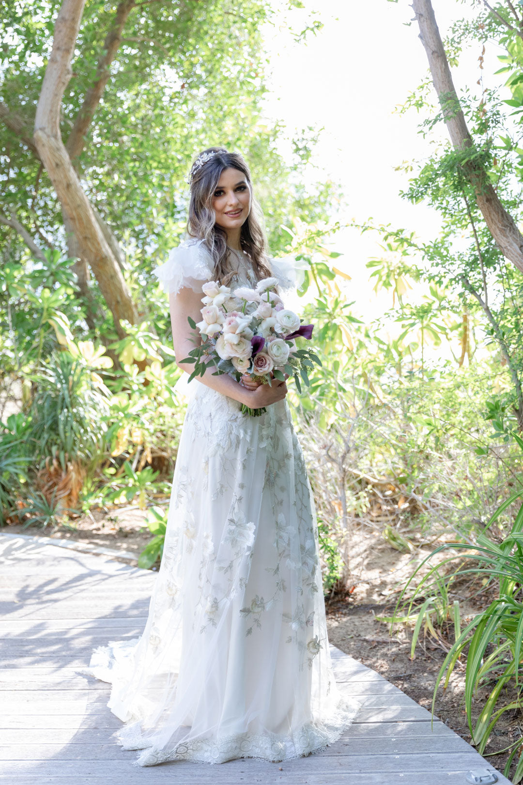 Bride holding floral bouquet for wedding photo