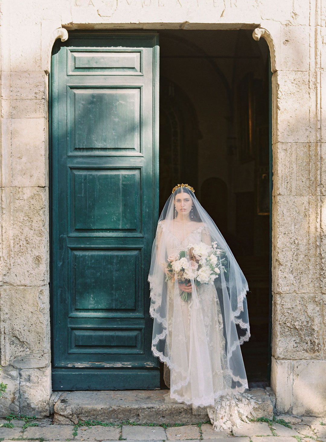 Bride in Wedding Veil holdng floral bouquet