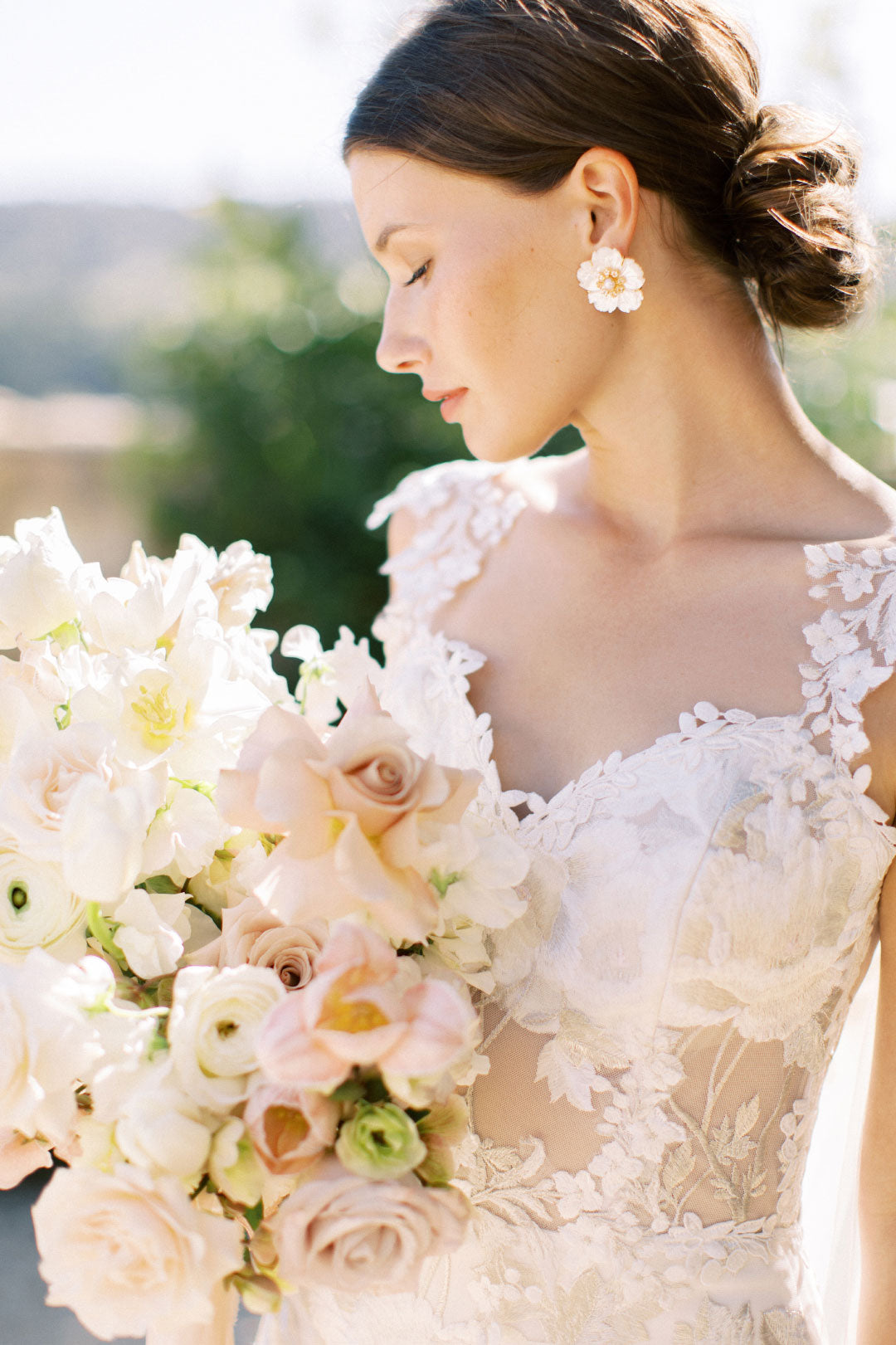 Bride in Odessa by Claire Pettibone holding wedding bouquet 