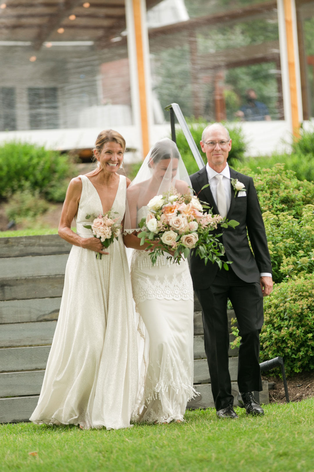 Bride walking the aisile with mother and father