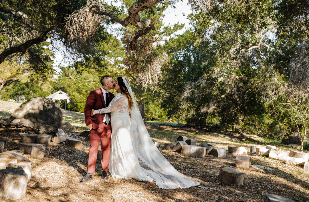 Bride and Groom kiss for wedding photo in field