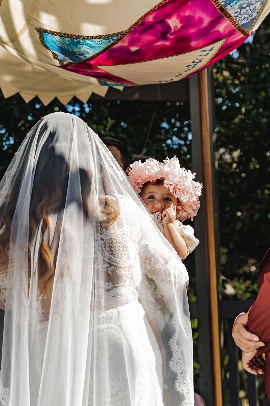 Bride holding her baby.