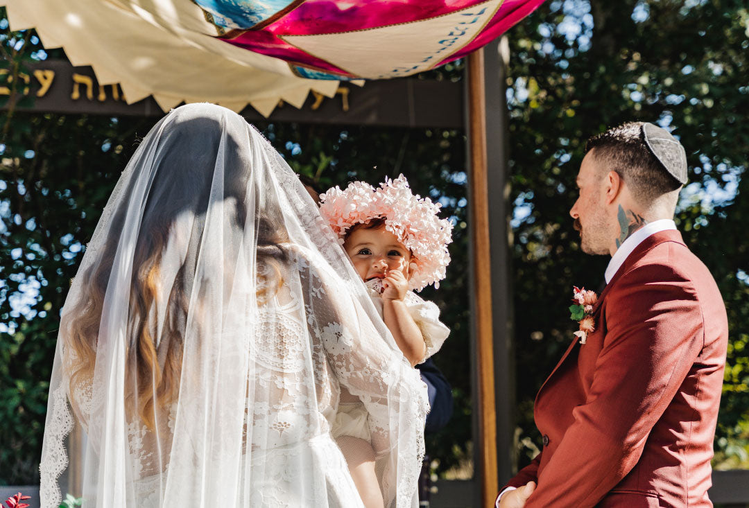 Baby in flower crown, Mother wearing wedding veil