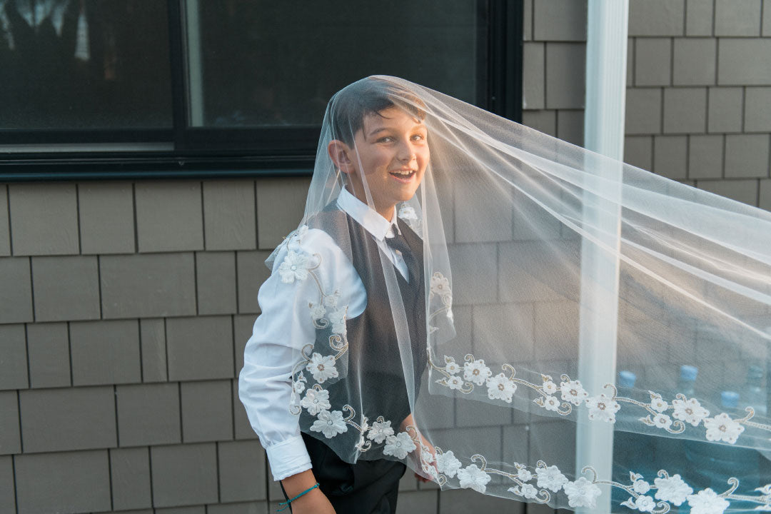 Bride in Leila by Claire Pettibone with son