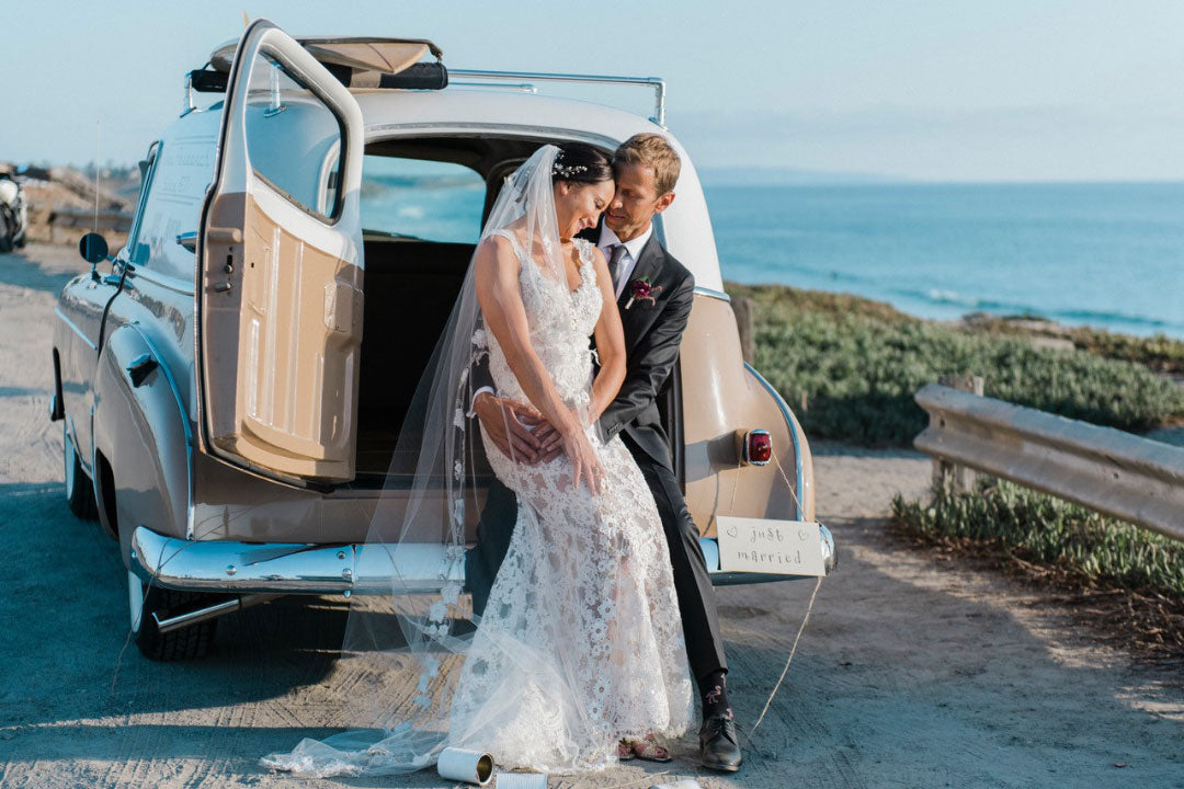 Bride and groom photos with car by beach