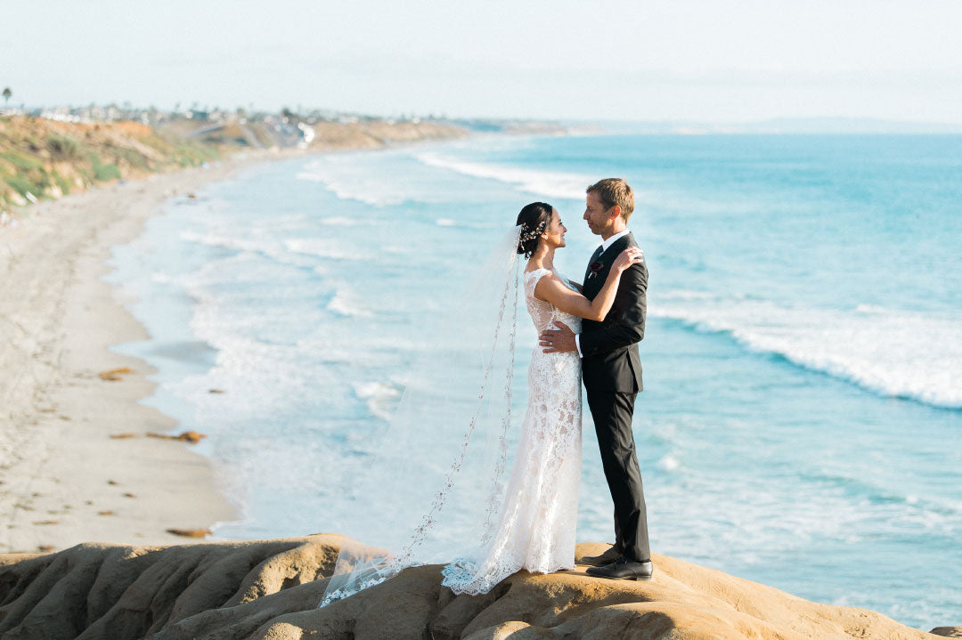 Bride and groom on beach bluff