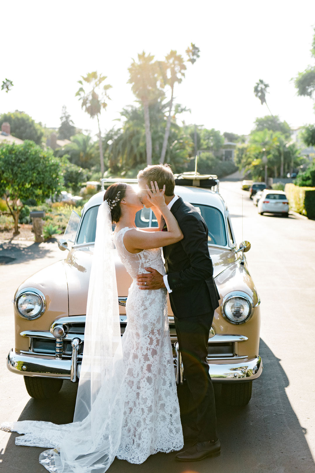 First look photo bride wearing lace wedding dress by Claire Pettibone