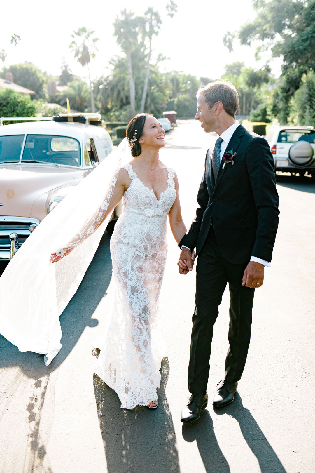 Bride wearing lace wedding dress by Claire Pettibone