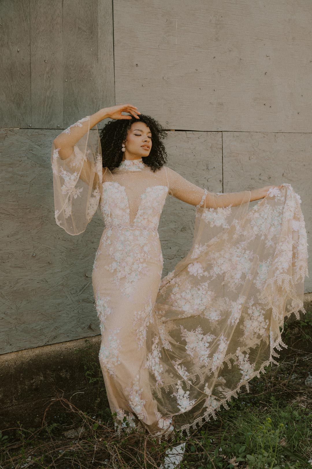 Model holding the train of Venus Couture Wedding Dress with color 