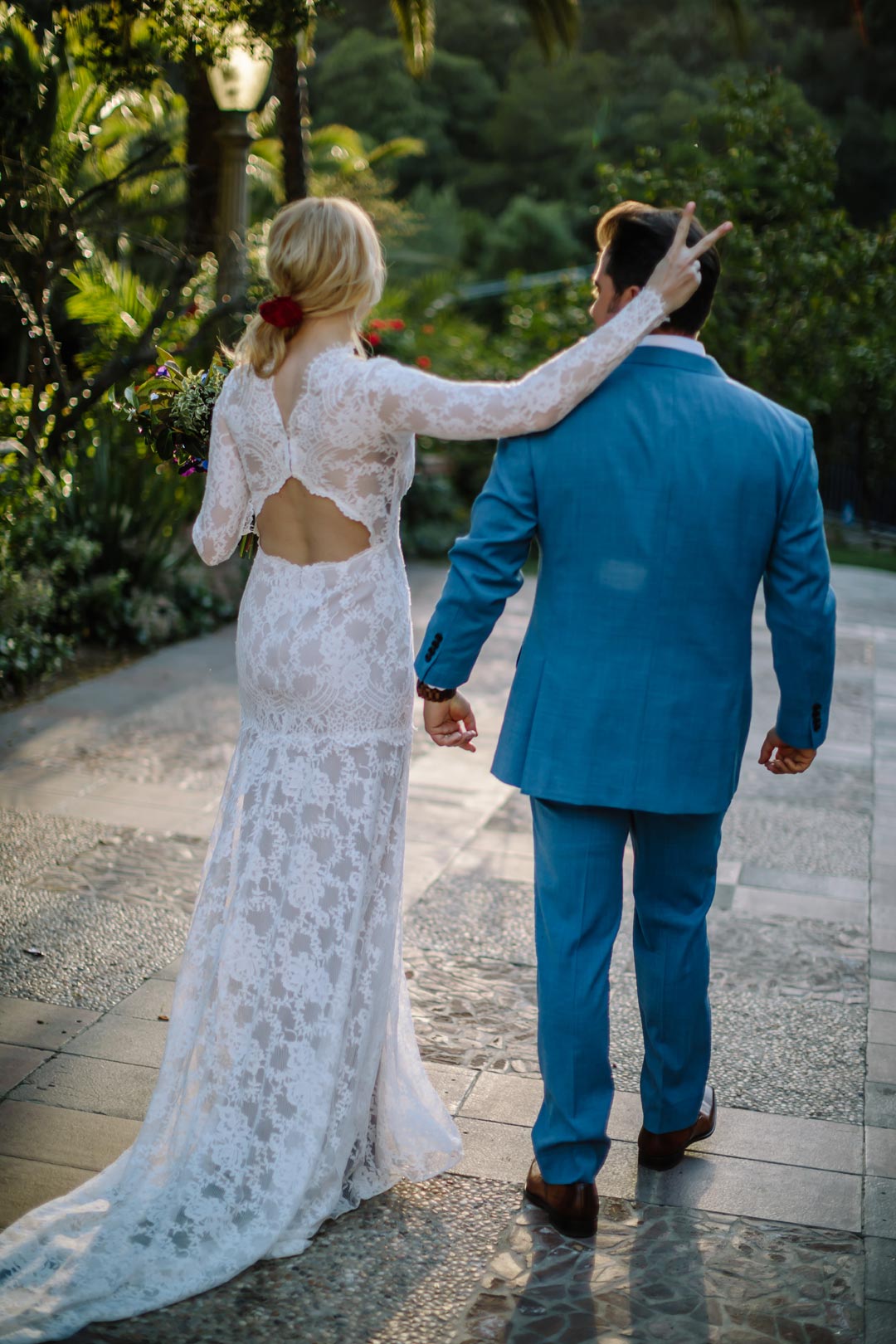 Bride with Rabbit ears behind Groom Wearing a Lace Wedding Dress