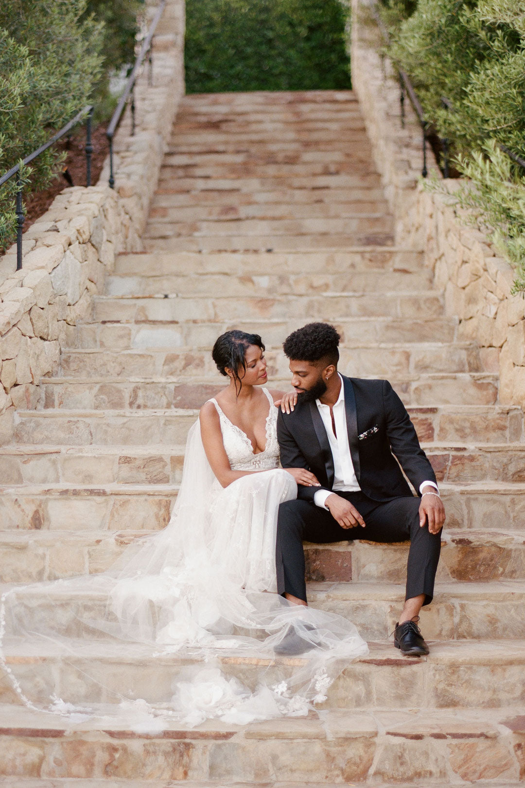 Bride and groom sitting on steps Klenter Ranch Wedding Venue