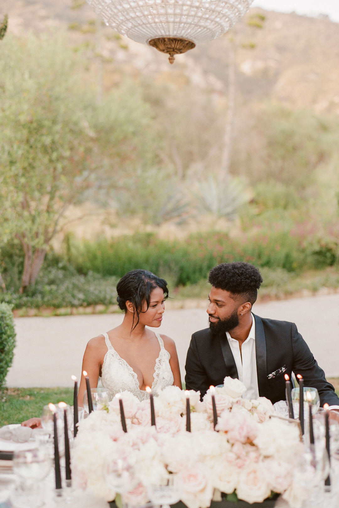 Bride and Groom Sitting at Wedding Table