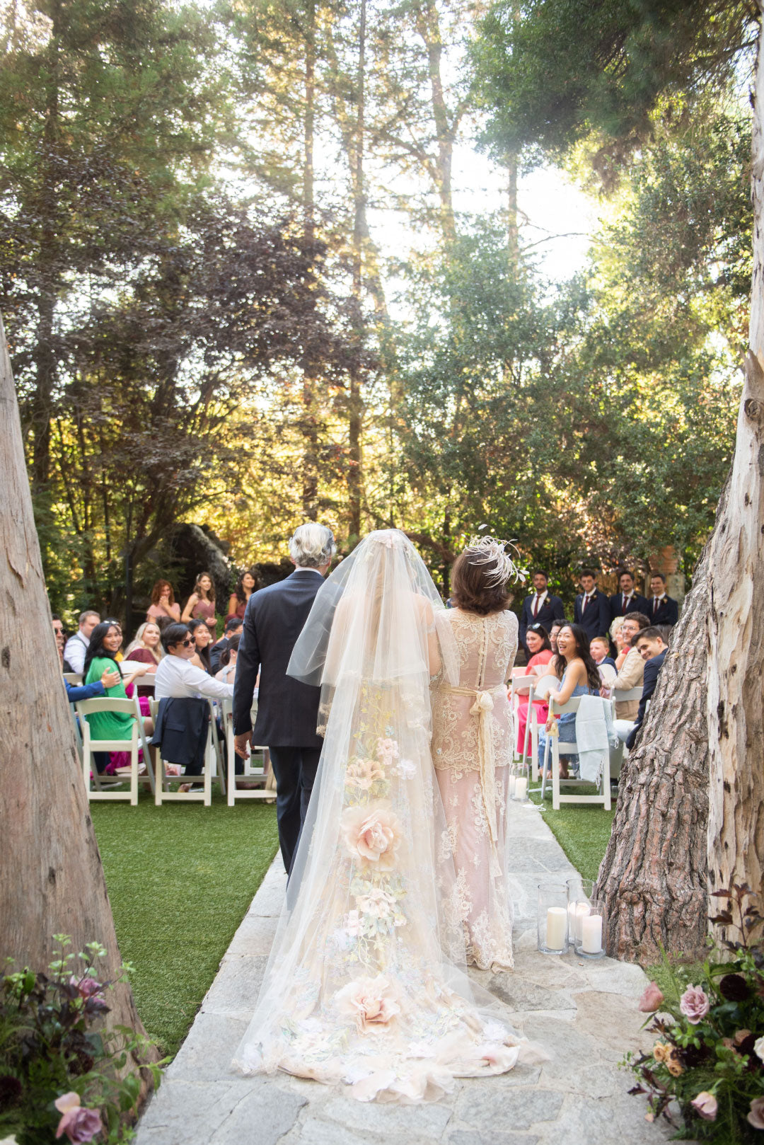 Bride walking to ceremony with parents view of Enchanted Rose Bridal Cape used as Veil