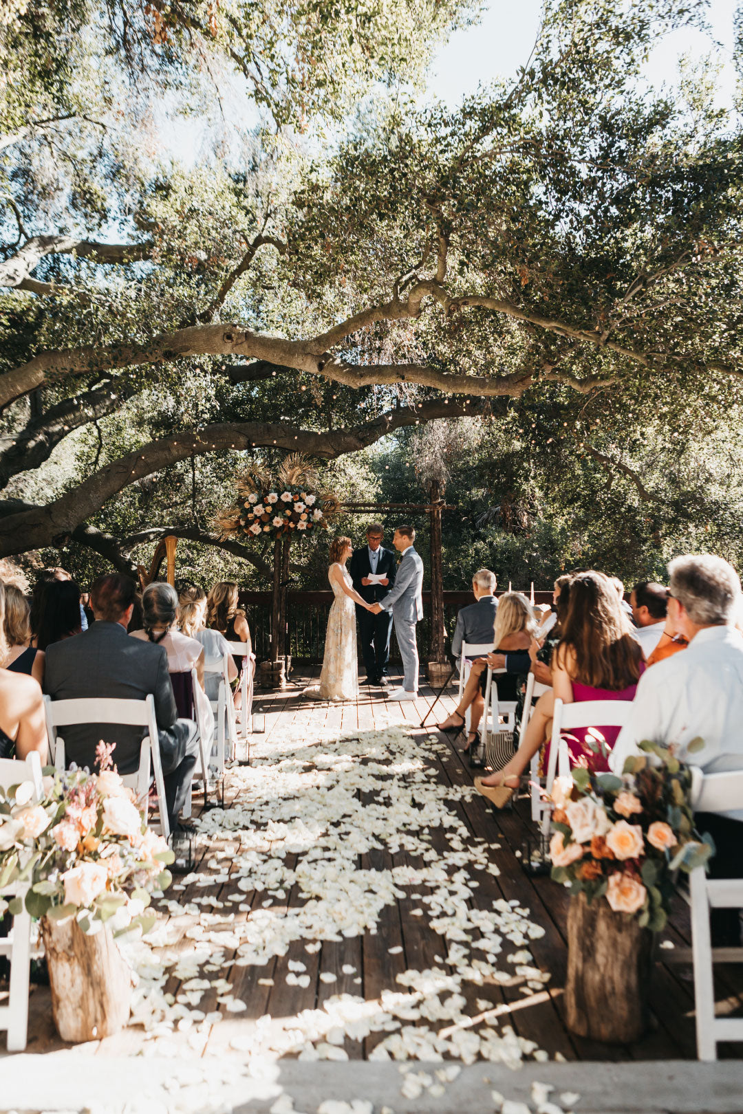 Bride and Groom taking vows under oak tree