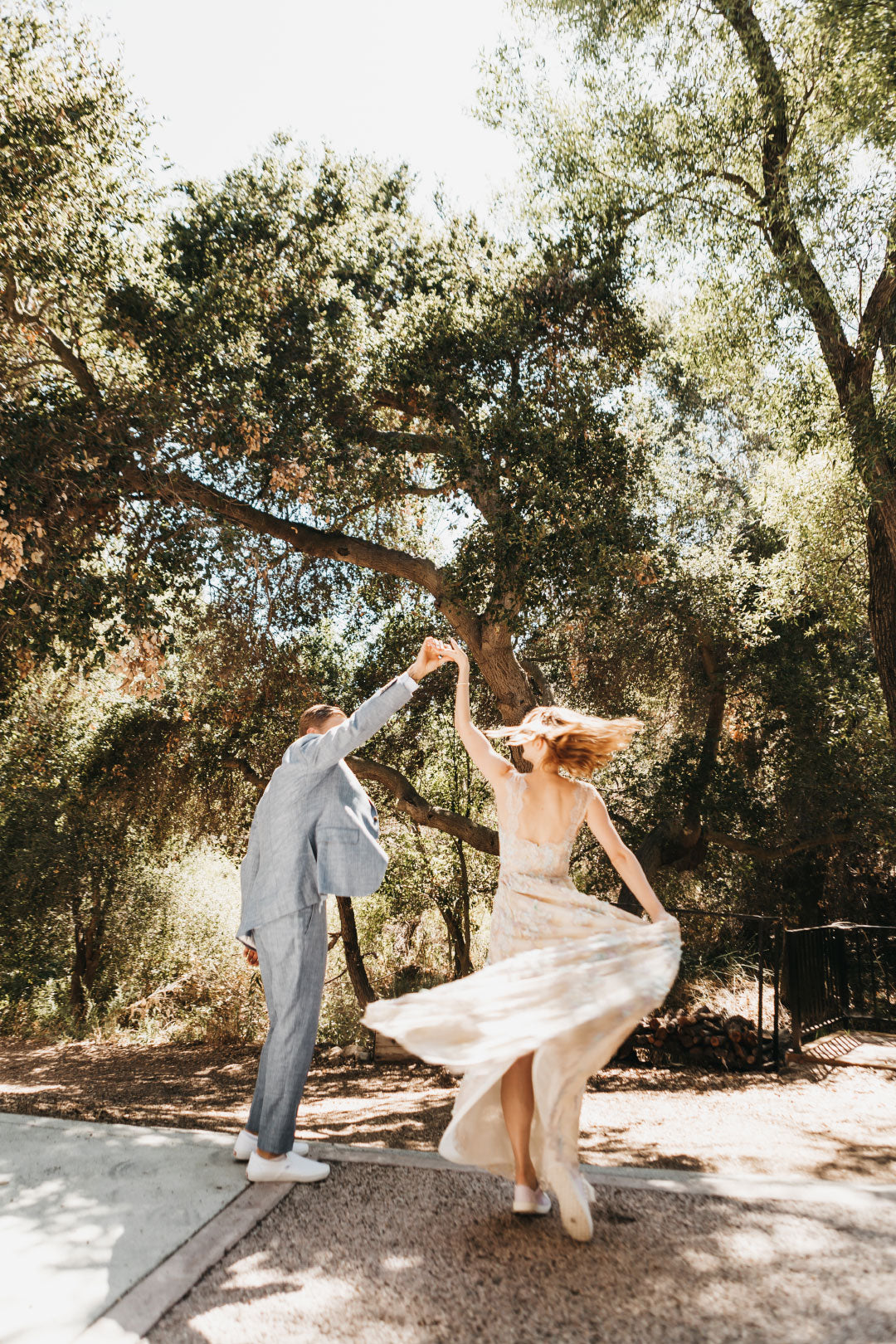 Groom twirls bride in wedding dress