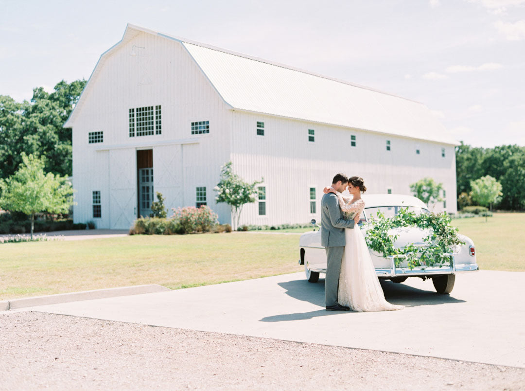 Bride and Groom in front of the White Sparrow Barn