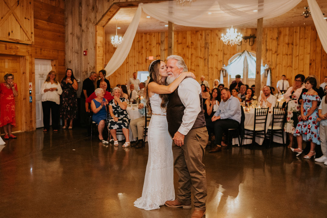 Bride embracing father at wedding celebration