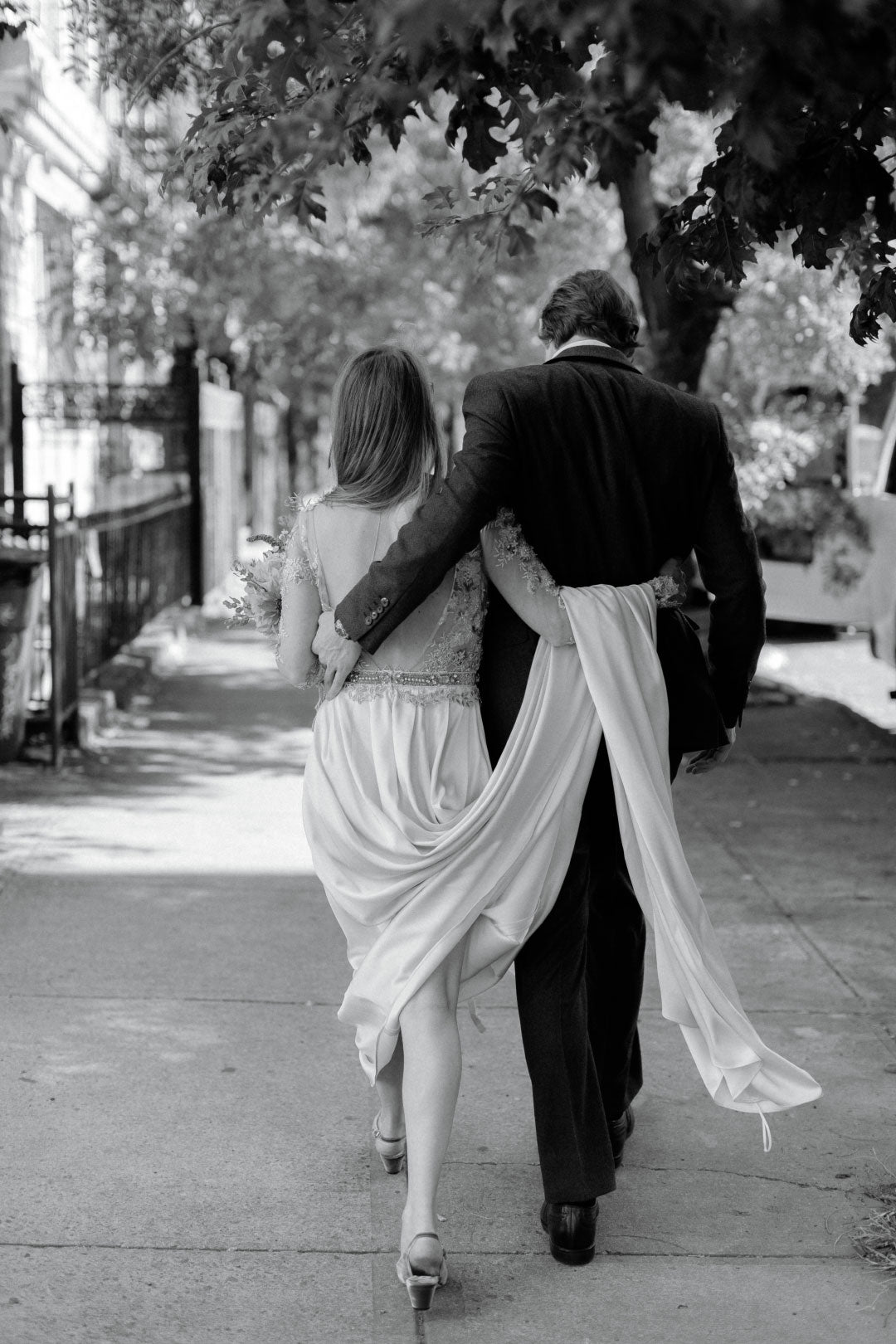 Bride and groom walking before wedding bride holding wedding bouquet