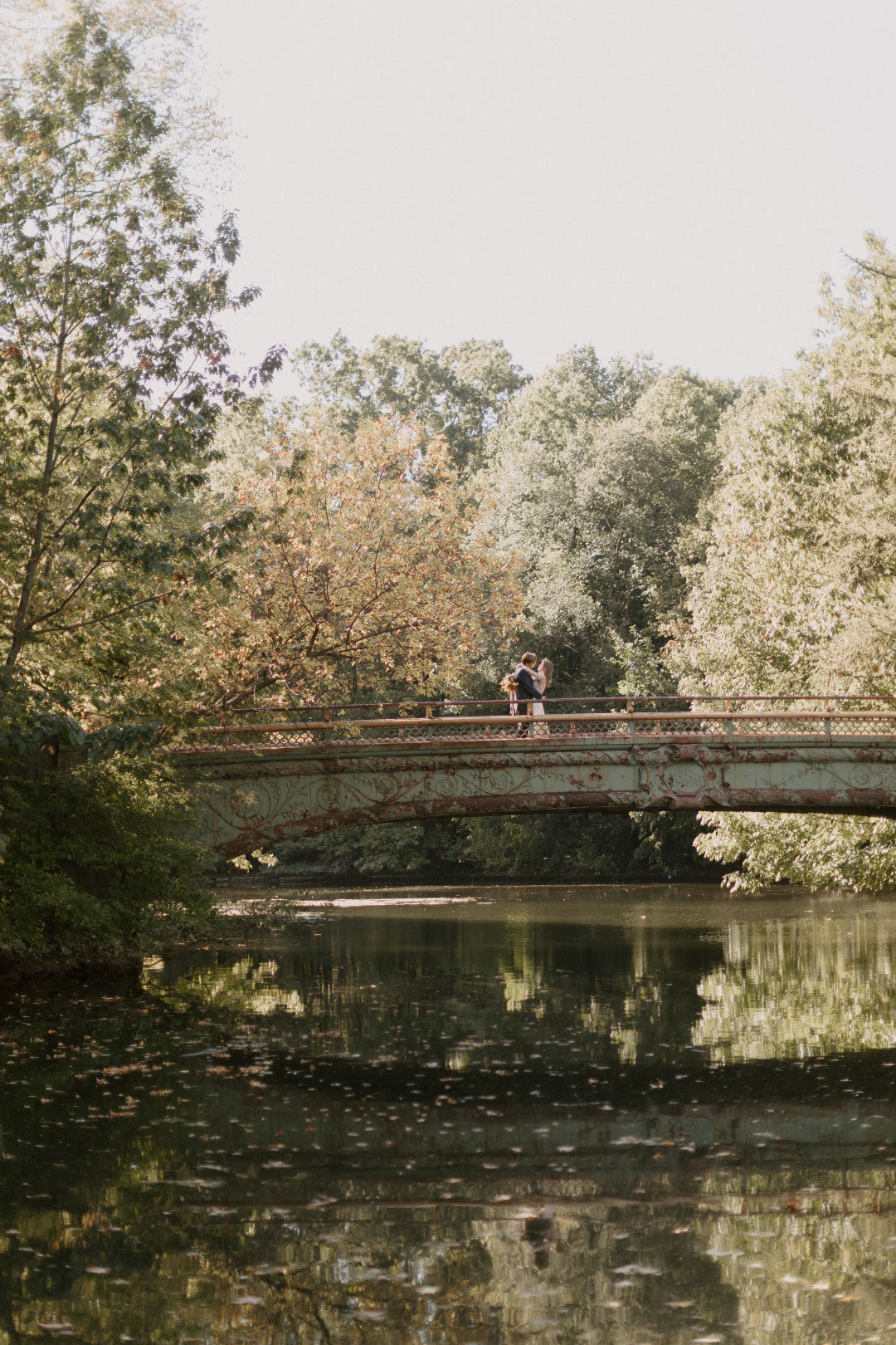 Wedding venue bridge over lake in park