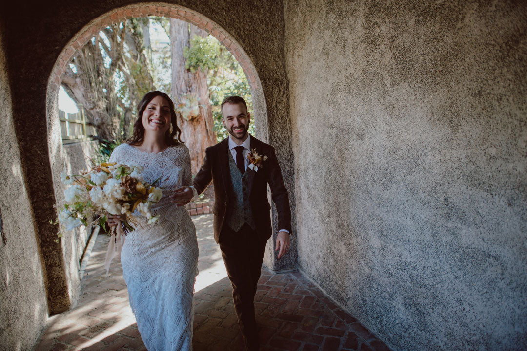 Bride and Groom walking together bride with wedding boquet