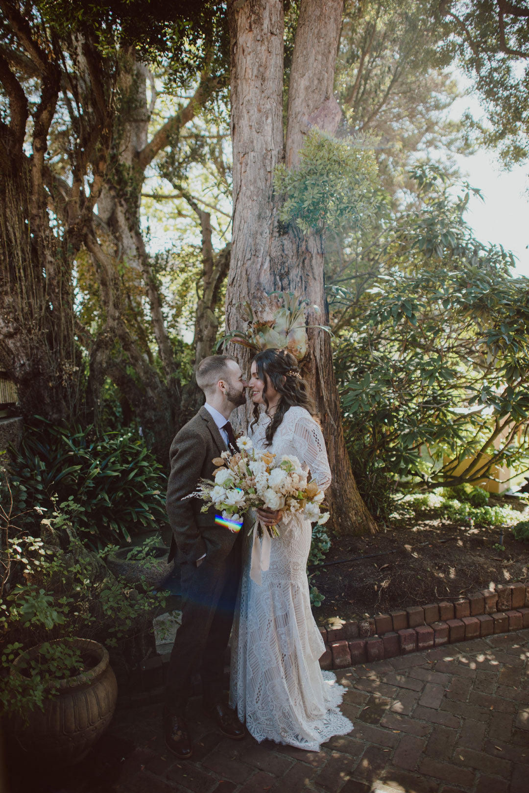 Bride and groom photo under tree