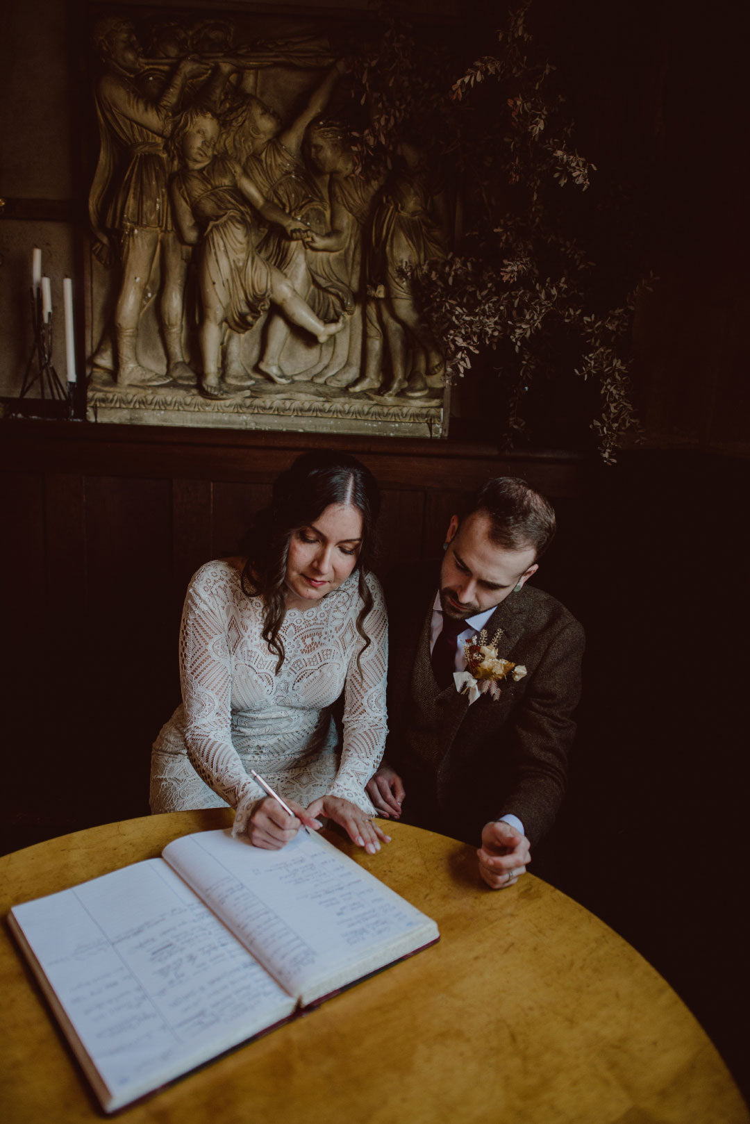 Bride and groom signing marriage book