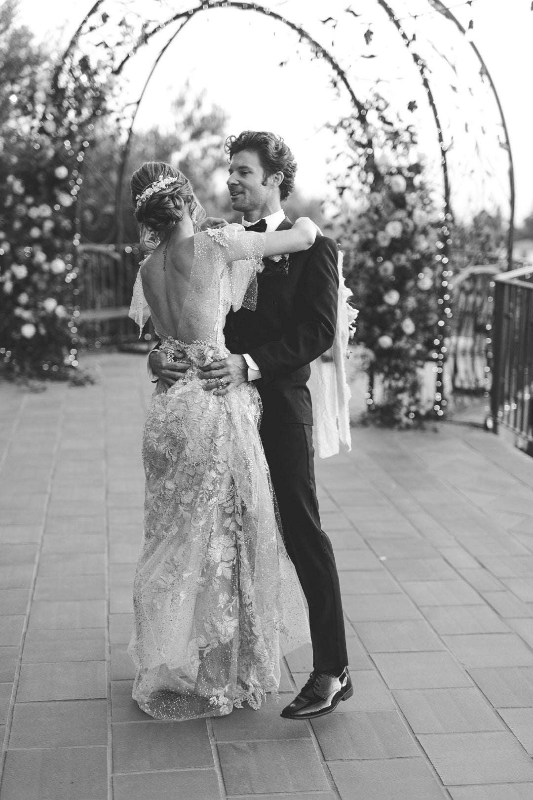 Black and white picture of bride and groom embracing
