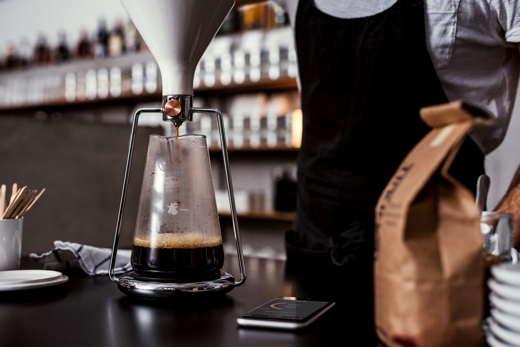 Barista is preparing coffee with GINA smart coffee instrument